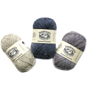 Three balls of Jamieson's Shetland Spindrift in pebble, blue, and a purple heather with label that says Jamieson's Shetland Spindrift